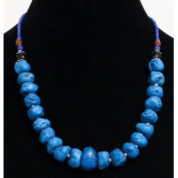 Ethnic artisanal necklace imitation misshapen blue stones separated from small metal...
