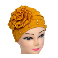 Beaded hat with a large flower on the side in solid mustard yellow color